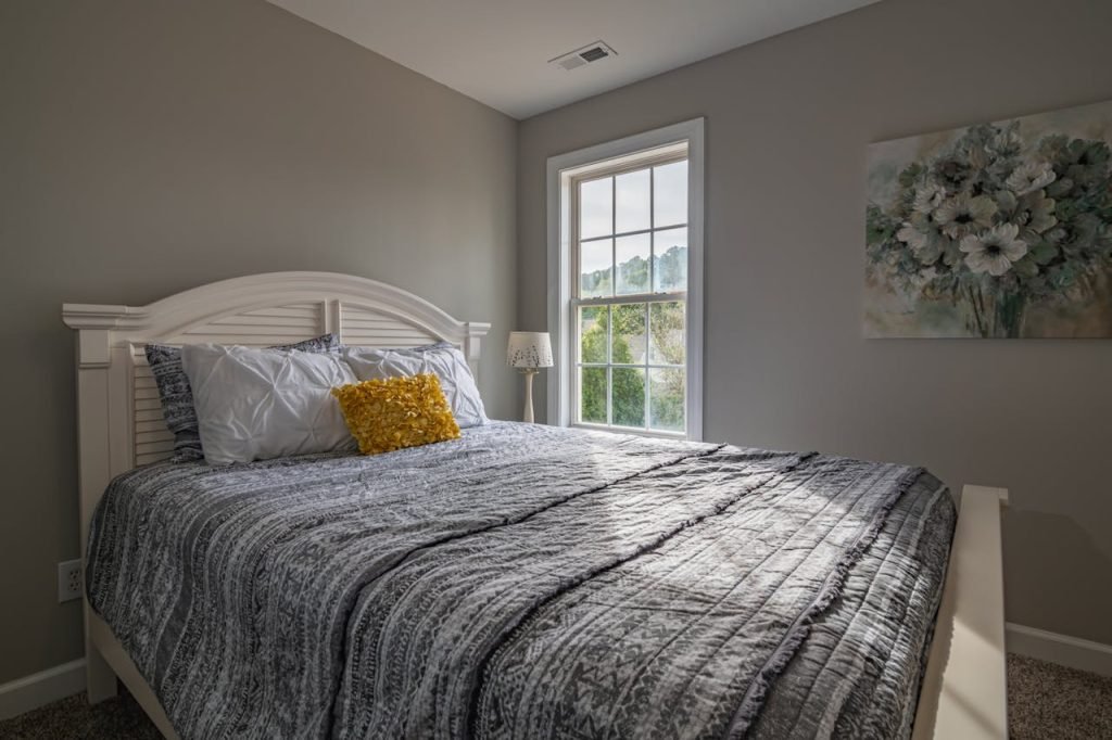 A warm, inviting bedroom with a double bed and natural light streaming in.